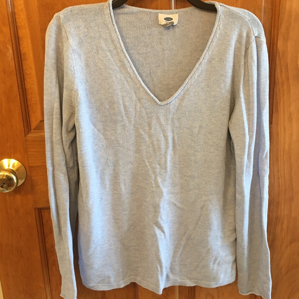A powered blue, v-neck sweater.